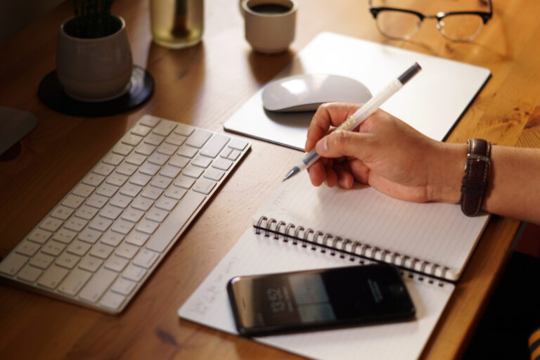 closeup-shot-entrepreneur-working-from-home-doing-calculations